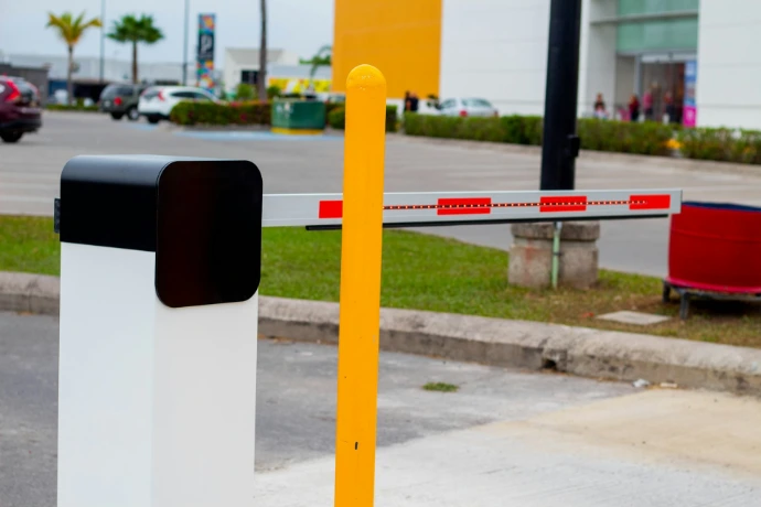 a yellow and white barrier sitting on the side of a road